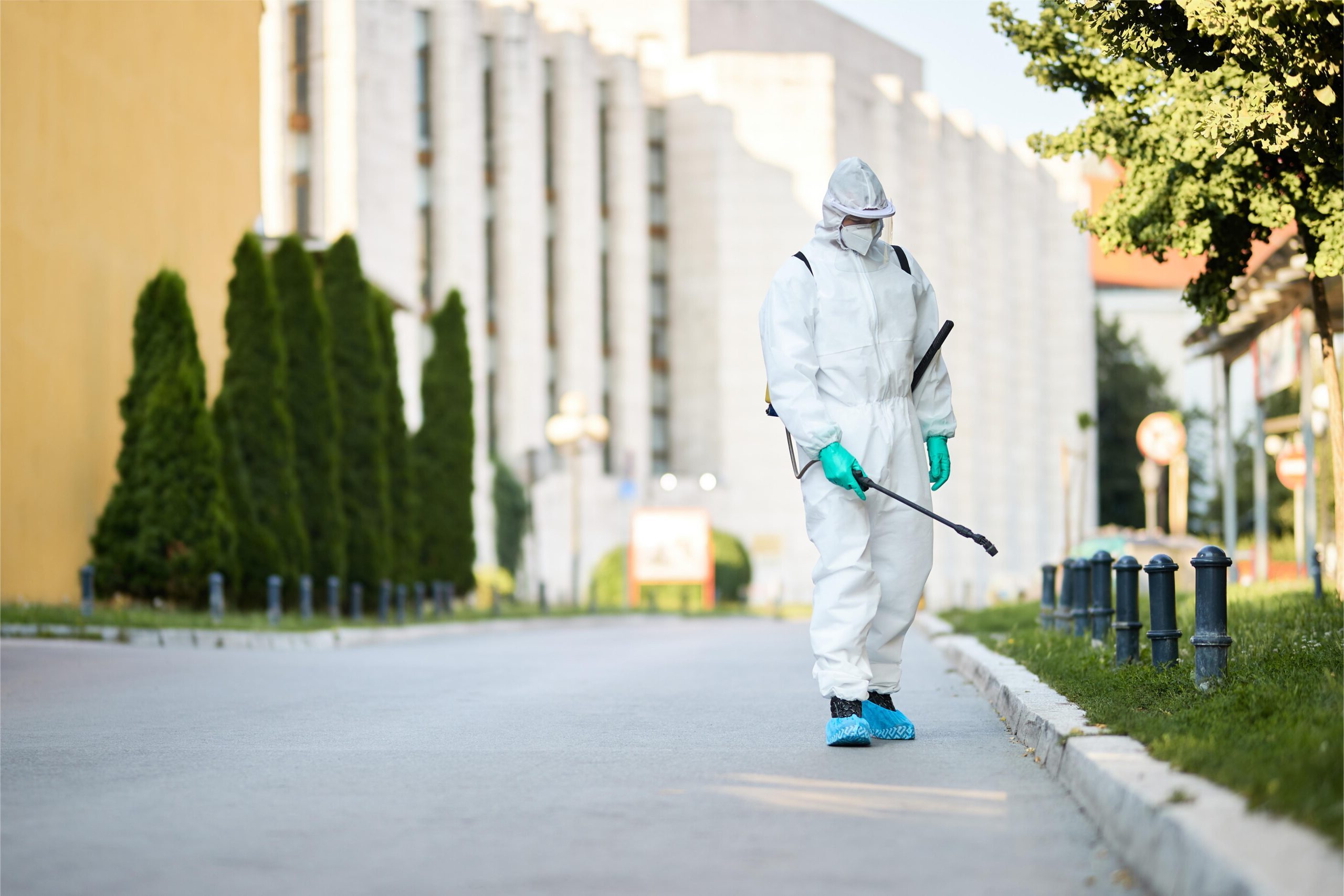 man protective suit disinfecting city streets coronavirus pandemic